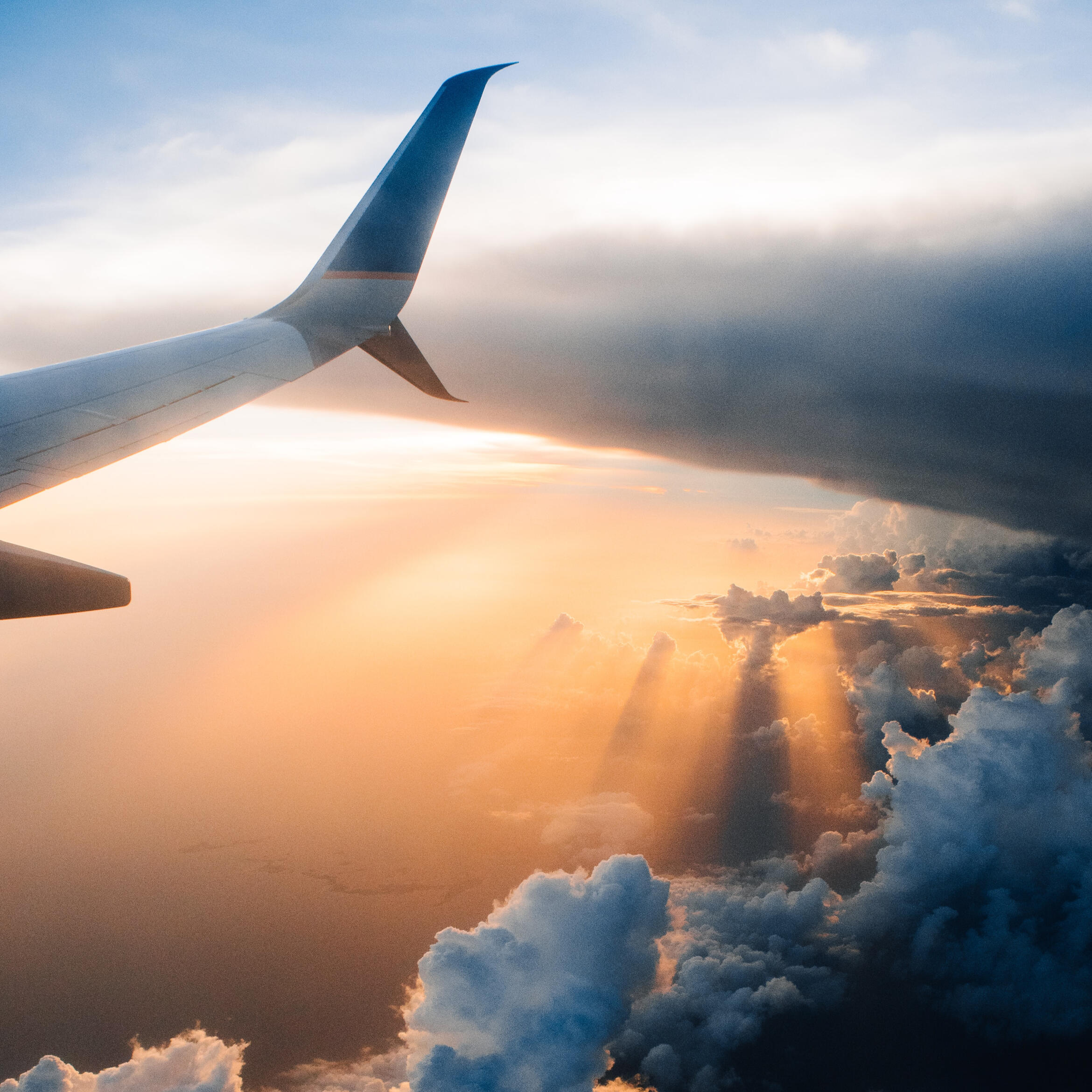 A commercial airliner flying through beautiful clouds