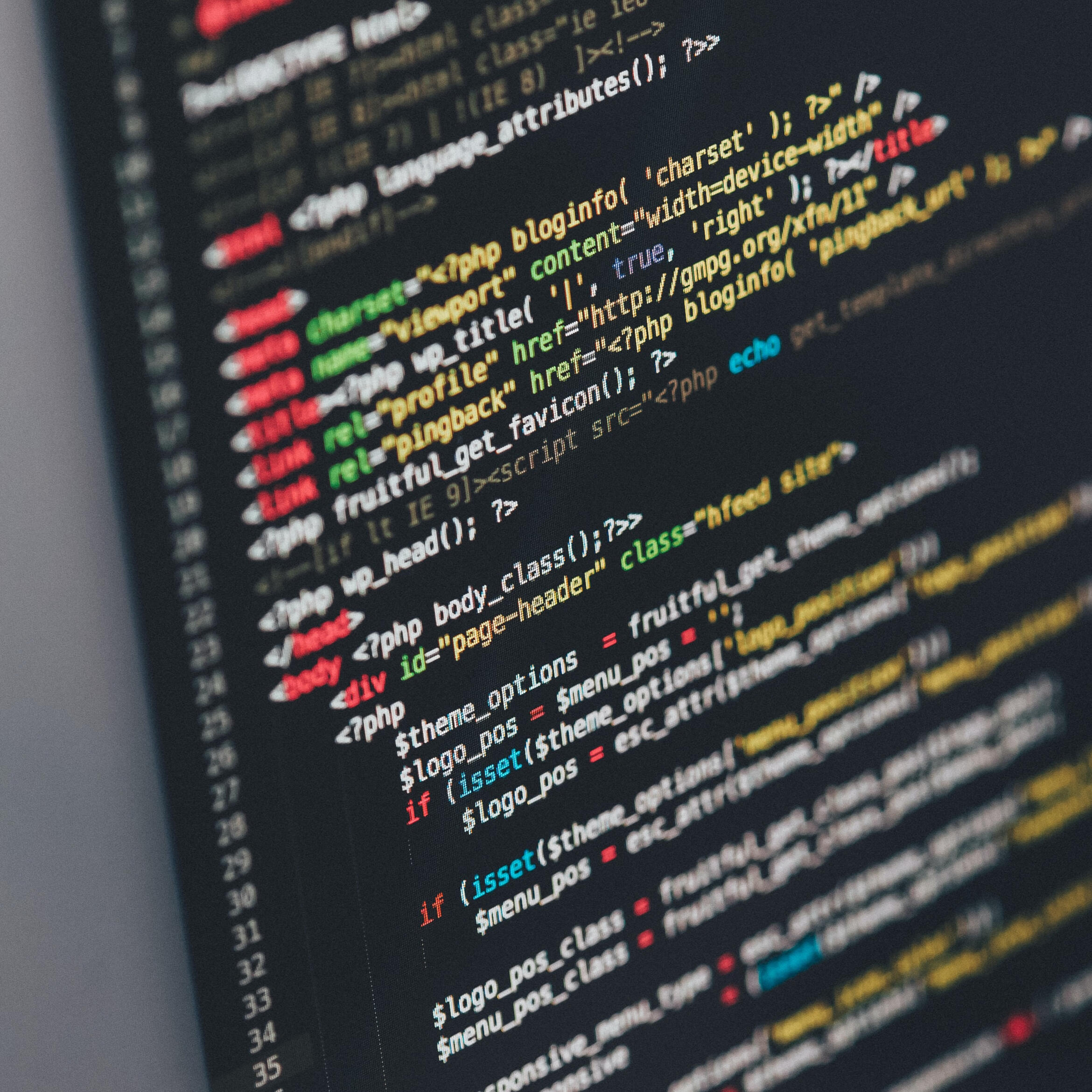 Colored computer coding language on a black computer screen.